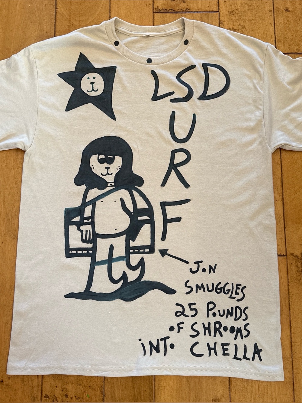 Graphic Coachella T-Shirt with Black Surfing Character